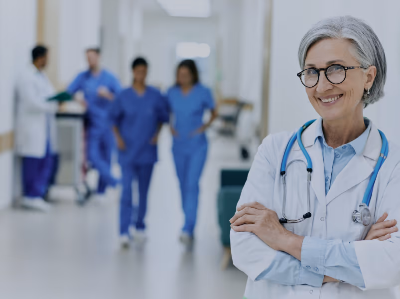 Senior doctor in a bright hospital corridor