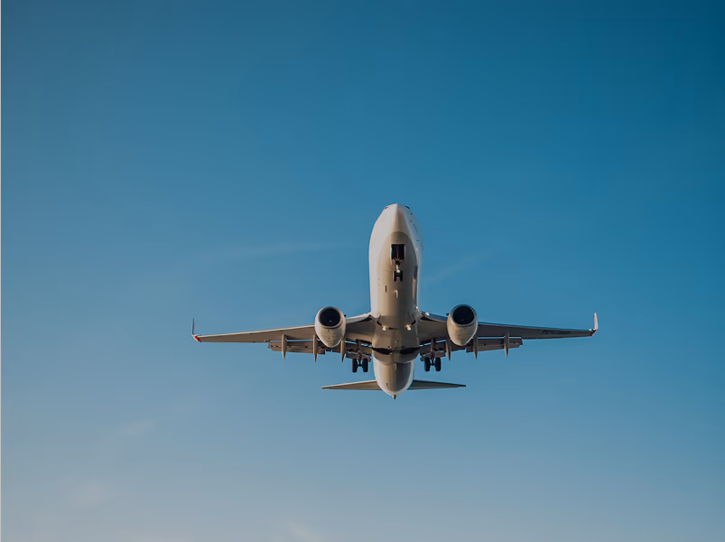 Passenger aircraft climbing against a clear blue sky